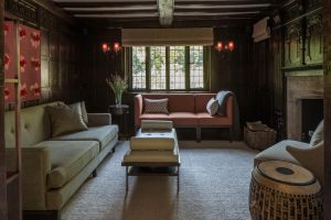 snug or reading room with terracotta three seat sofa and drum style side table