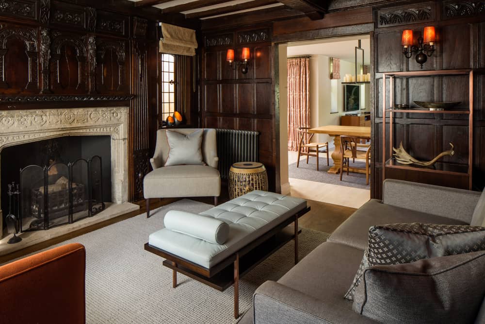 snug or reading room with fireplace and upholstered ottoman
