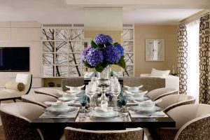 blue and violet hydrangea are a striking centre piece on this lavish dining table