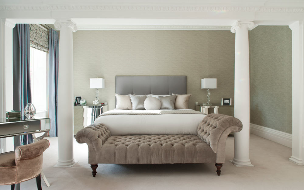 hotel luxury bedroom with a neutral colour palette, metallic silk textures and velvet chaise lounge at the foot of the bed by roselind wilson design