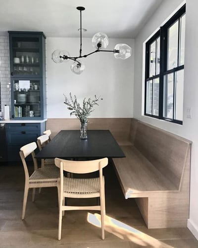 Breakfast nook with rattan chairs, pendant light and neutral colour palette. 