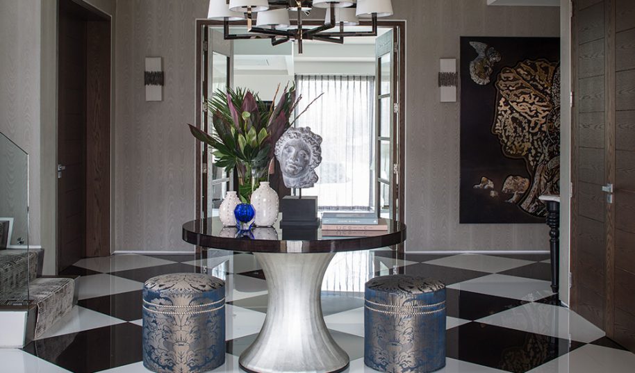luxury entrance hallway with round table and spider pendant chandelier