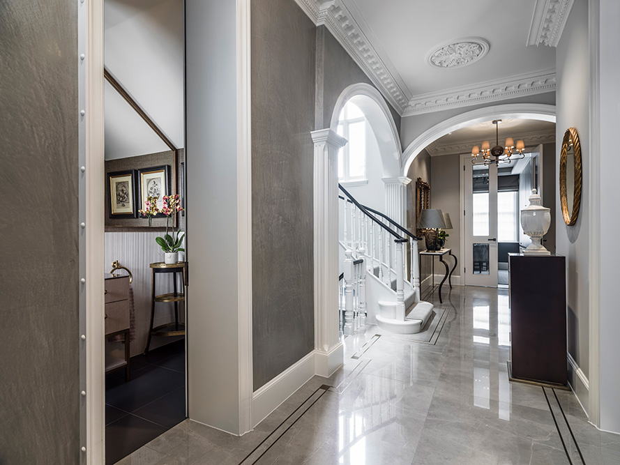 luxury entrance hall with guest bathroom, staircase and architectural details