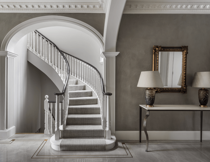 Luxury curved staircase next to console table