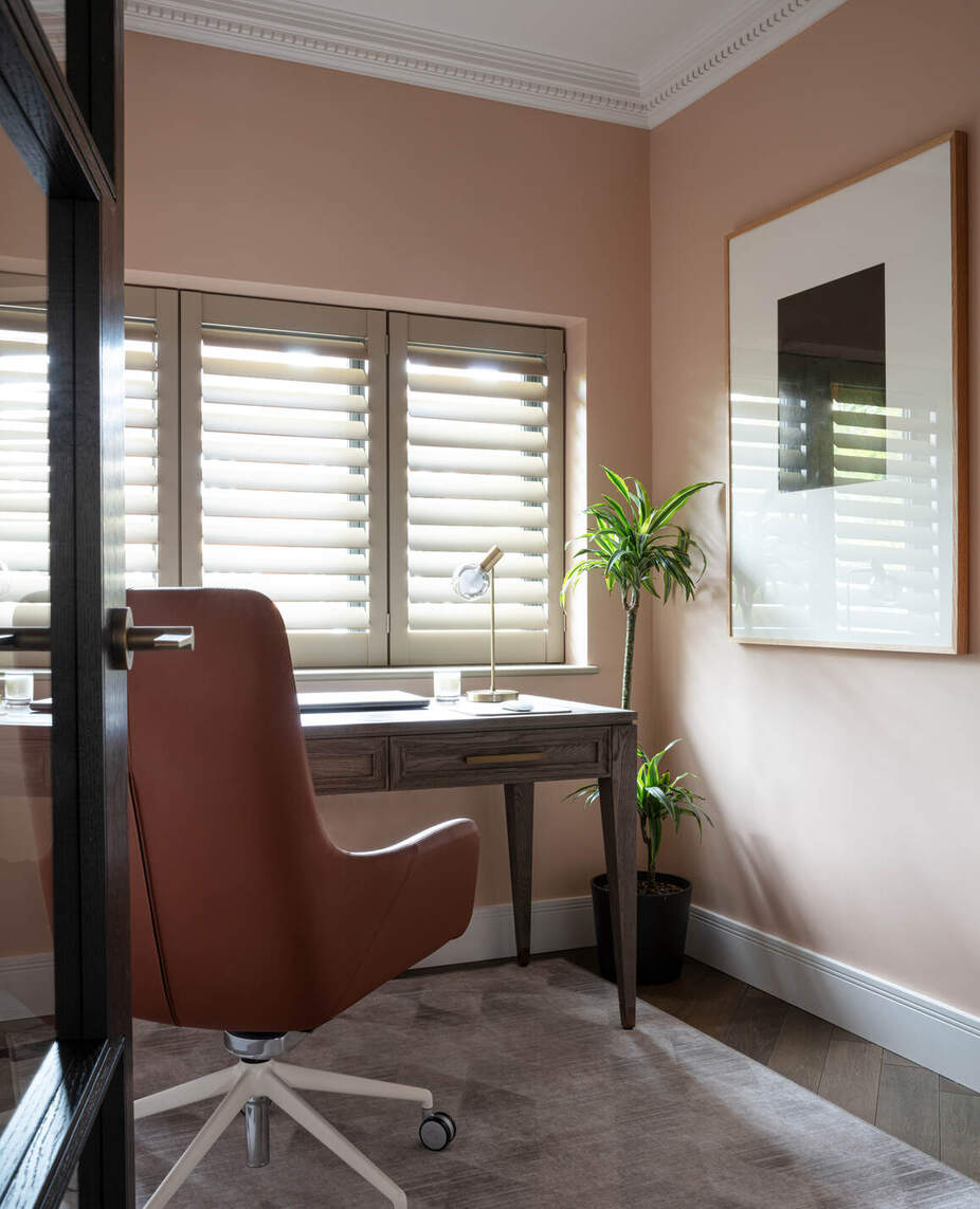 Office with peach walls and chair