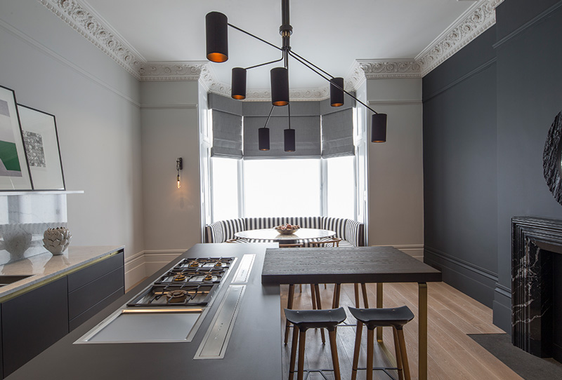 contemporary monochrome kitchen with bay window seating and fireplace