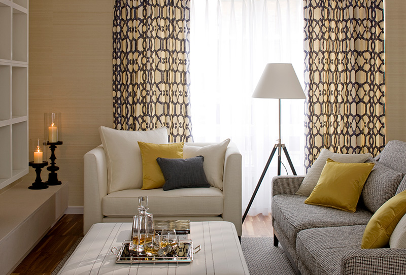 modern living room in neutral colour palette of grey, white and gold