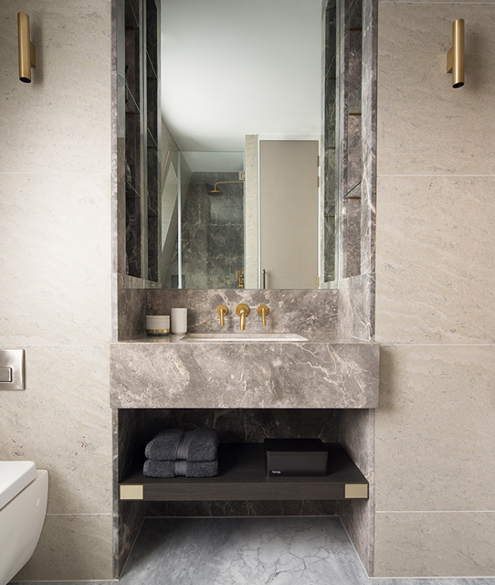 bespoke marble bathroom vanity with symmetrical brass wall lights