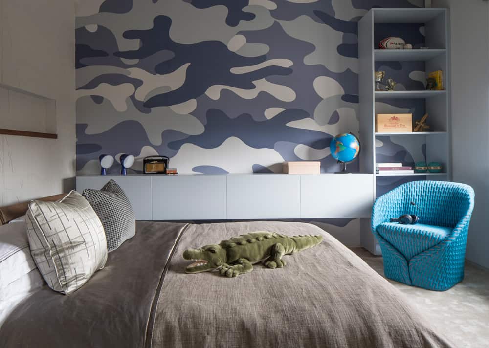 children's blue and grey bedroom with patterned wallpaper