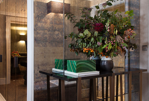 metal console table and antique mirror wall