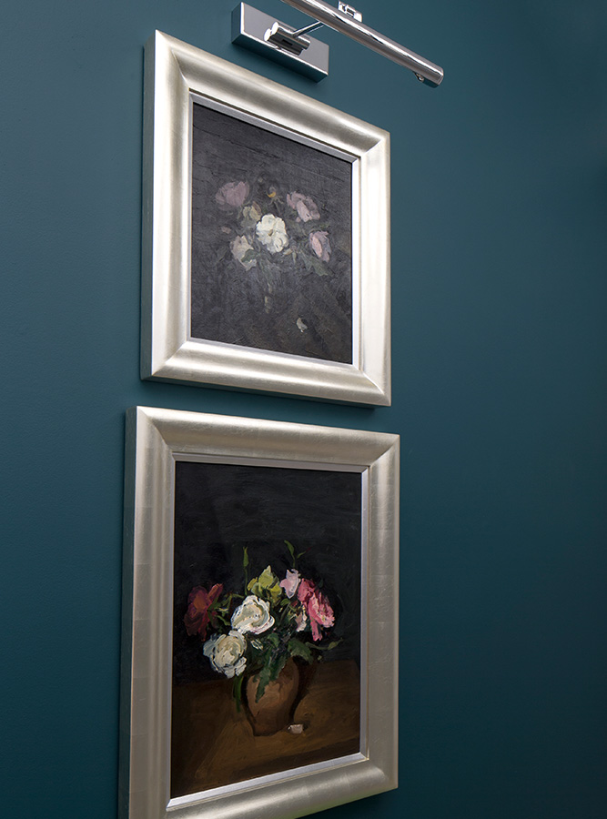 luxury entrance hallway artwork set against dark blue wall