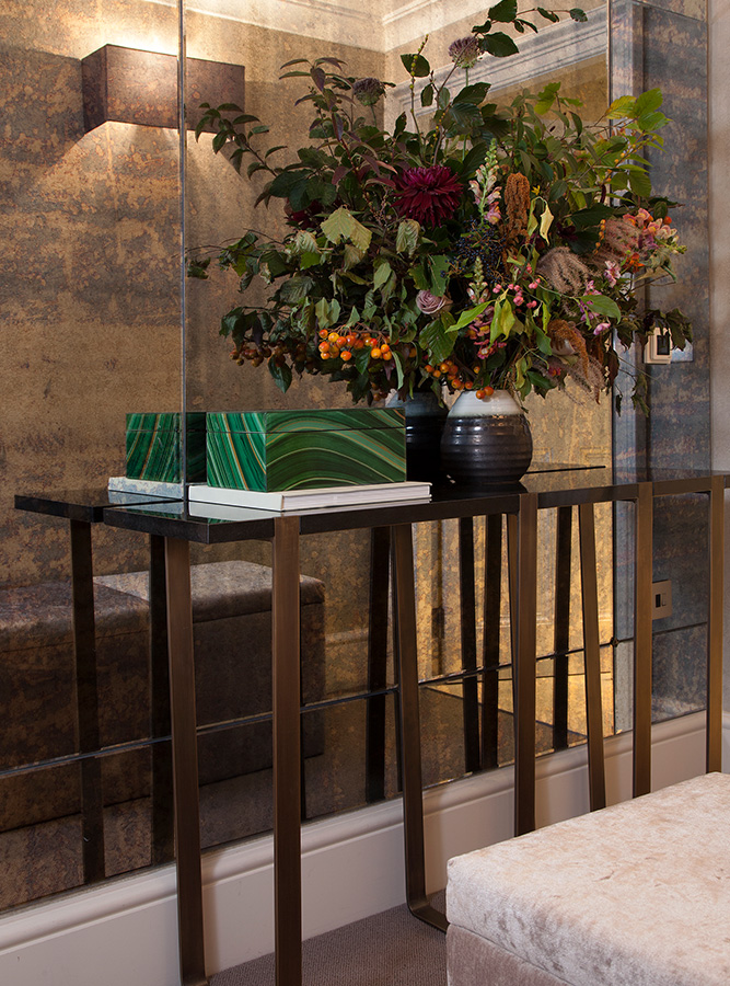 luxury entrance hallway with antique mirror glass and metal console table