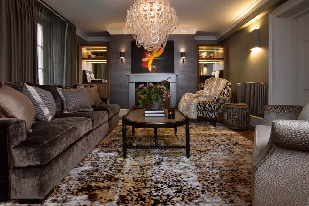 luxurious living room with dark colour palette and striking chandelier