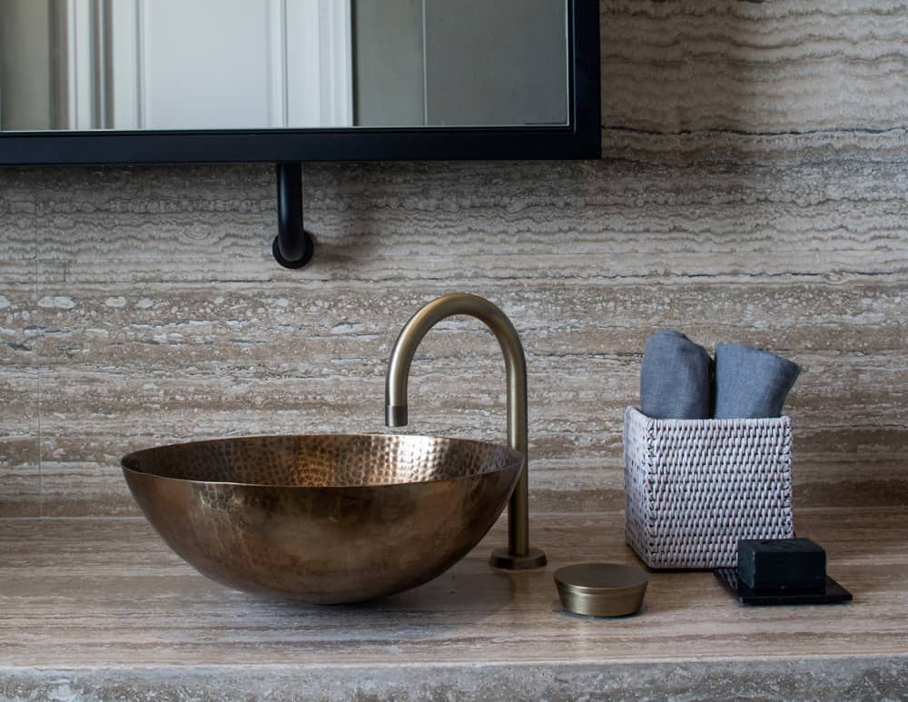 the sanitaryware in this contemporary bathroom is finished in vintage brass to complete the sophisticated industrial look