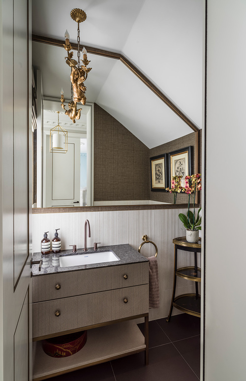 small cloakroom with textured bathroom vanity and cherub chandelier