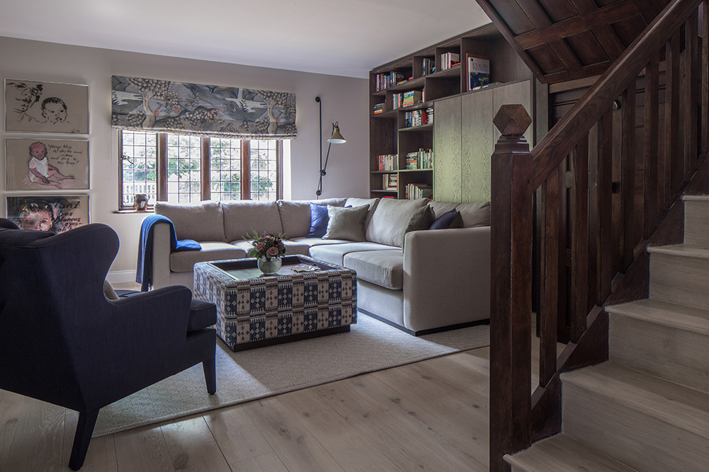 tv room with large L-shaped sofa and bespoke joinery